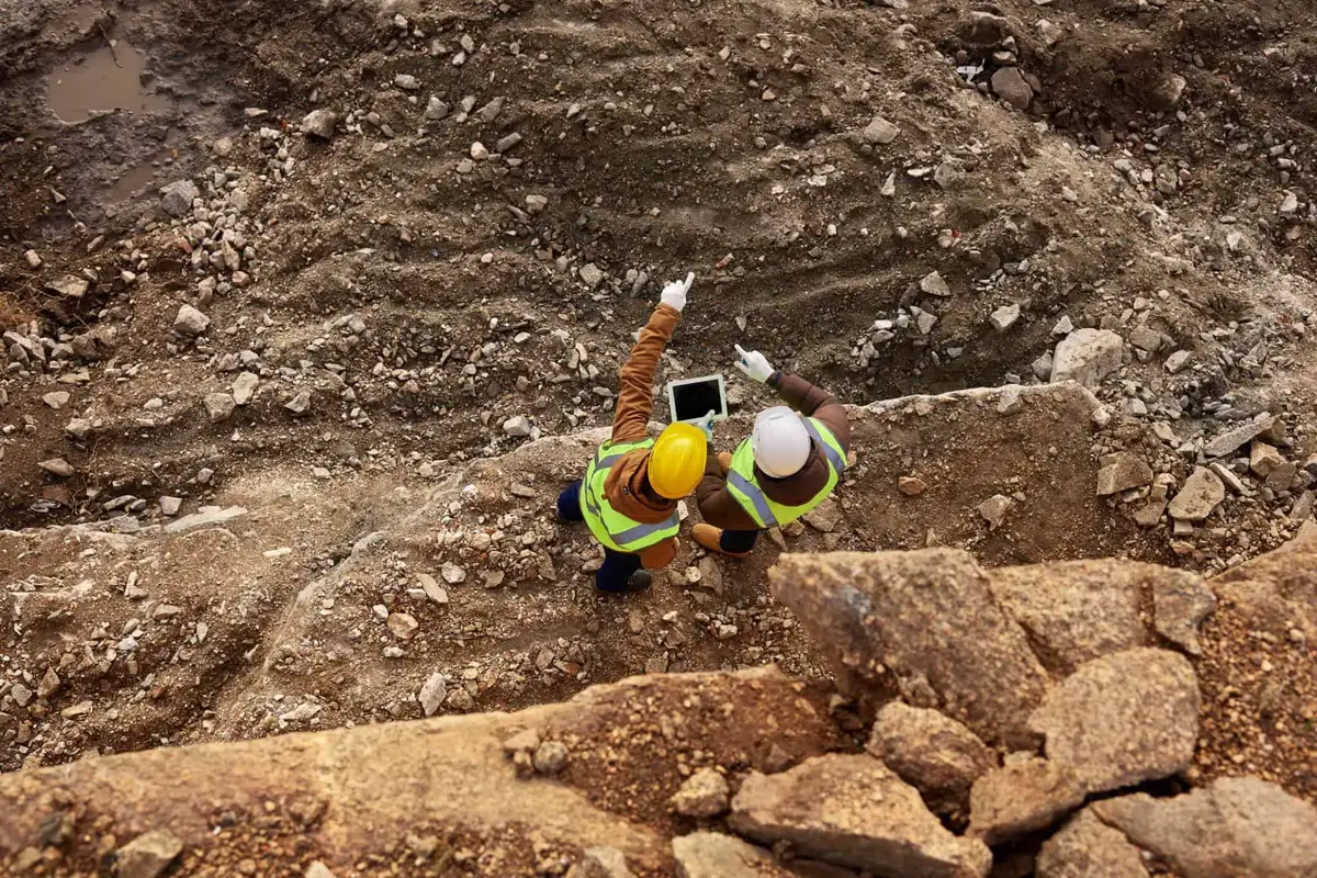 construction workers inspecting site soil