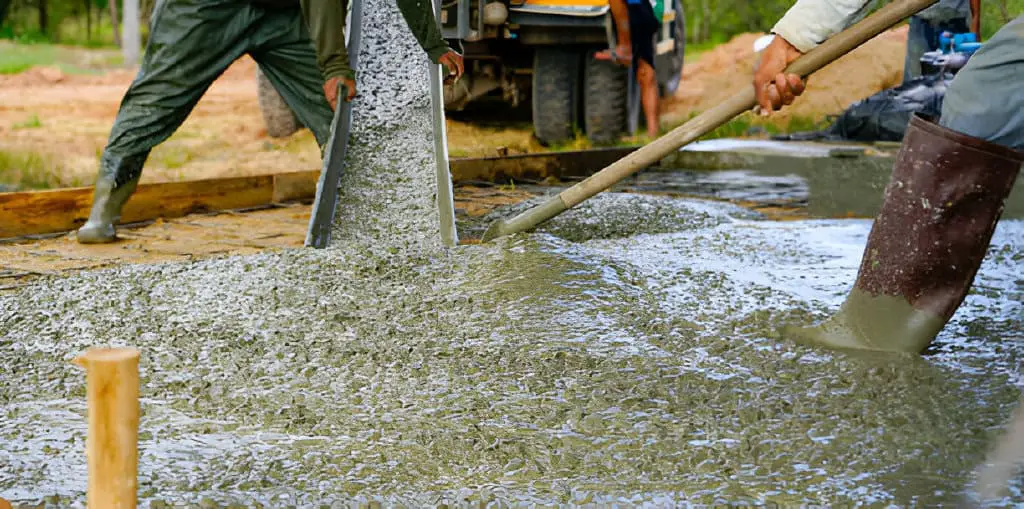 construction worker pour wet concrete at construction site